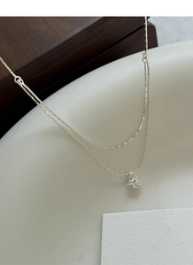 Detail of S925 sterling silver double layer necklace with a round cubic zirconia pendant