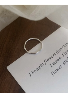 Macro detail of silver bamboo joint ring with smooth polished metallic texture