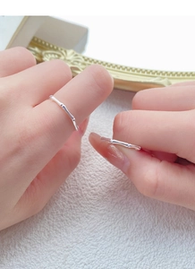 Detailed view of two S999 silver bamboo joint rings worn on a hand in light luxury style