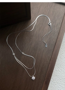 Detail view of S925 sterling silver stamp on the double-layer minimalist diamond necklace