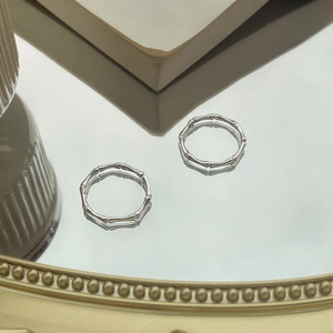 Elegant S999 sterling silver bamboo joint rings set on a reflective mirrored surface