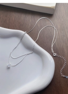 Detail view of S925 silver double layer necklace with bright round solitaire pendant