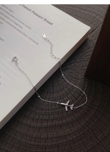 Detailed close-up of a S999 sterling silver airplane bracelet with sparkling zircon accents