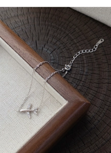 Macro shot of S925 silver airplane bracelet with cubic zirconia wings on wooden background