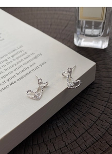 Detail of S999 silver heart earrings with irregular hammered texture and small zircon