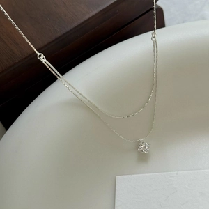 Double-layered S925 sterling silver necklace with sparkling round zircon pendant on dark wood