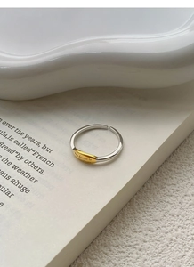 Detailed close-up of S925 silver ring featuring gold-toned plate with engraved letters