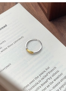 Close-up of S925 silver adjustable ring with gold contrast and motivational engraving