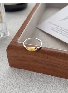 Detail of S925 silver adjustable ring with gold plate and engraved text message