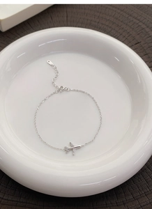 Macro detail of silver airplane bracelet with sparkling micro-pave zircons and lobster clasp