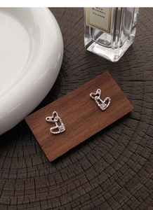 Detailed macro view of S999 silver double heart stud earrings with hammered texture and zircon