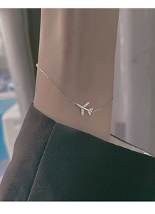 Close-up of S999 silver airplane bracelet with sparkling crystals on a woman wrist
