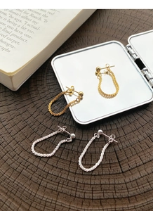 Detail of S925 sterling silver chain drop earrings in gold and silver finish