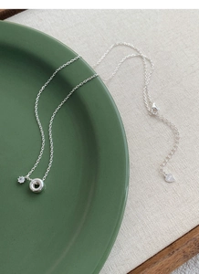 Detailed macro of S925 sterling silver chain with heart-shaped tag and S925 engraving