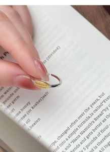 Detailed macro view of S925 silver ring featuring a gold oval plaque with engraved quote
