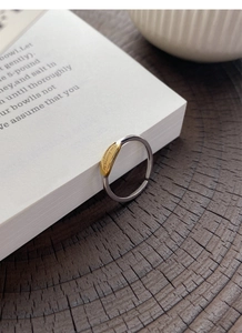 Detail of S925 silver ring with golden accent and engraved text You deserve to be loved