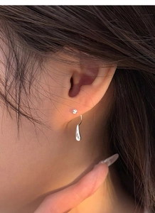 Detailed view of S999 silver water drop earrings featuring a minimalist screw-back design