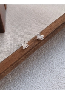 Detail of silver rocking horse stud earrings with white mother-of-pearl inlay