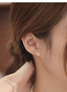 Gros plan d'un mannequin portant des boucles d'oreilles gourde en argent S999 évidé