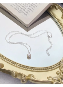 Détail du collier en argent sterling S925 avec perle d'eau douce sur plateau à miroir