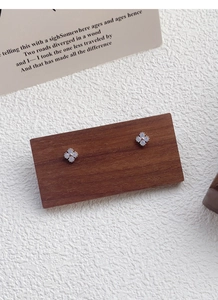 Macro view of Aurora S999 silver four-leaf clover earrings with pale blue gemstones