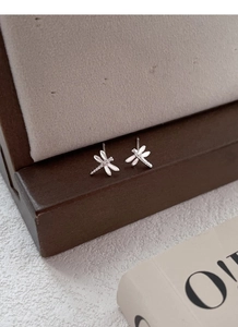 Detailed close-up showing the intricate wing textures of the S999 silver dragonfly studs