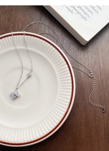 Macro detail of S925 sterling silver four-leaf clover necklace with sparkling cubic zirconia