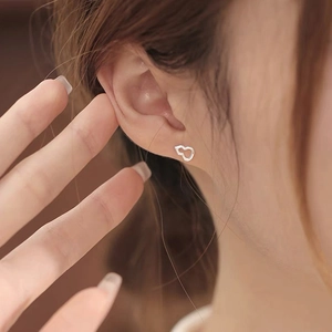 Élégantes boucles d'oreilles clous en argent S999 évidées en forme de gourde sur modèle femme