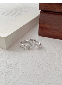 Close-up of S925 sterling silver flower earrings showing the hallmark stamp details