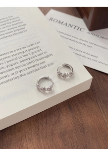 Close-up of S925 sterling silver flower hoop earrings with sparkling zircon stones