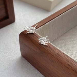 Minimalist S999 sterling silver swallow stud earrings with detailed feather textures