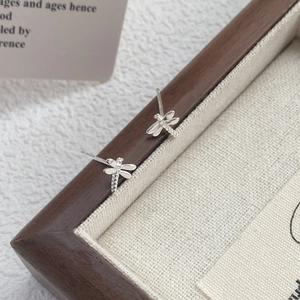 Minimalist S999 sterling silver dragonfly stud earrings with detailed wing texture