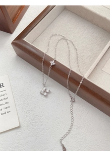 Detail view of S925 silver four-leaf clover necklace with sparkling cubic zirconia stones