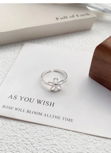 Macro shot of S925 sterling silver open ring with delicate hollow five-petal flower detail