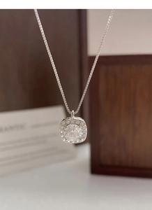 Close-up of S999 sterling silver cube pendant necklace with halo zircon setting