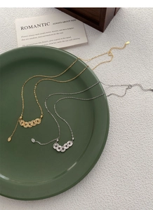 Detailed close-up of S925 sterling silver coin necklaces in gold and silver finishes