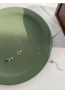 Dettaglio macro del ciondolo a zucca in argento S925 con calcedonio verde su ceramica