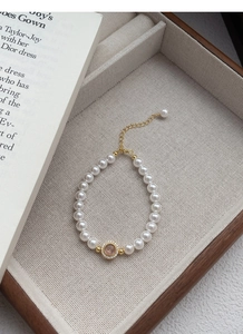 Detail of S925 silver pearl bracelet with a pink pendant and sparkling crystals