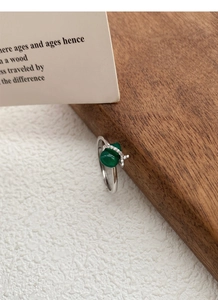 Detail of S925 silver ring with green chalcedony stone and white diamond accents