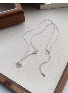 Detailed view of S925 sterling silver clover pendant necklace with sparkling zircons