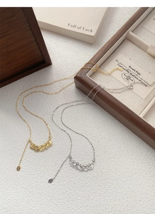 Detail view of S925 sterling silver necklaces in gold and silver finish with coin pendants