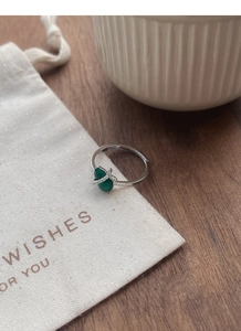 Macro detail of S925 sterling silver ring with green chalcedony and diamond accents