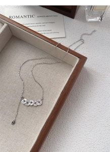 Detail of S925 silver five-coin necklace with tassel chain in a luxury jewelry gift box