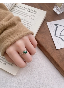 Detail of s925 silver ring featuring a green heart gemstone and micro-pave diamond setting
