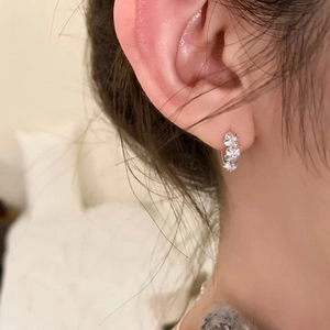 Elegant S925 sterling silver flower hoop earrings with zircon, worn by model