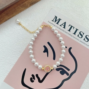 S925 sterling silver pearl bracelet with a pink gemstone center and adjustable gold chain