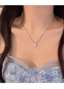 Close-up of S999 sterling silver necklace with sparkling round zircon pendant on model