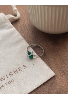 Macro detail of S925 sterling silver ring with green chalcedony stone and cubic zirconia