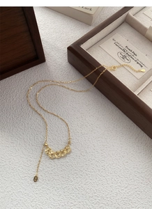 Detail of S925 silver five-coin pendant necklace with Ping An charm on white leather