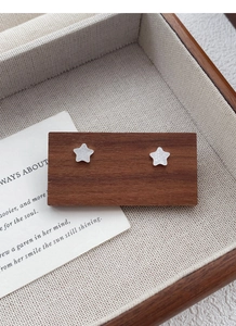 Detail of S999 sterling silver star stud earrings with a textured crushed ice finish